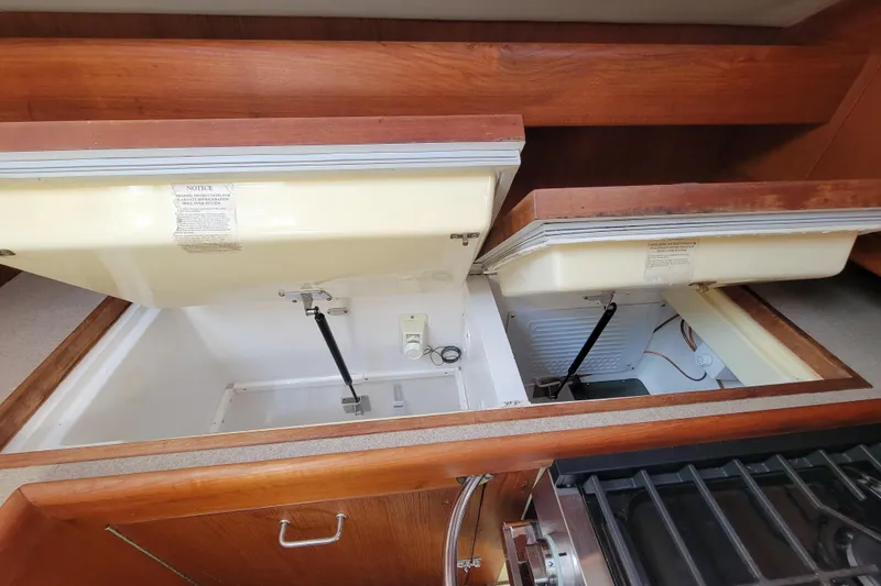 Slide: The Image of Open storage compartments in a 2001 Hunter Passage 420 sailboat interior. - 17