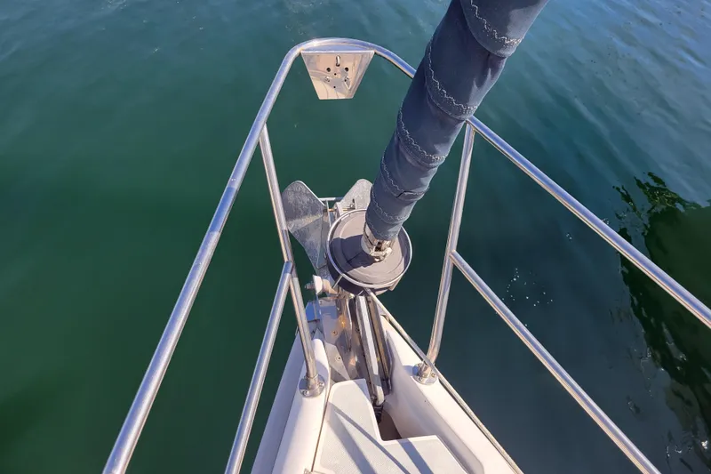 Slide: The Image of Bow of 2001 Hunter Passage 420 sailboat with anchor and calm water. - 2