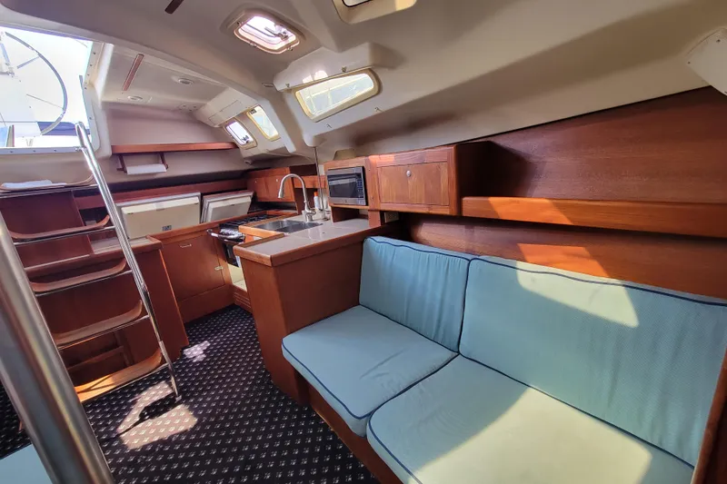 Slide: The Image of Interior of 2001 Hunter Passage 420 yacht with cozy seating and modern kitchen. - 20