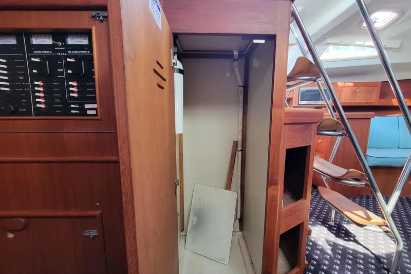 Slide: The Image of Interior of 2001 Hunter Passage 420 sailboat showing electrical panel and cabin details. - 22