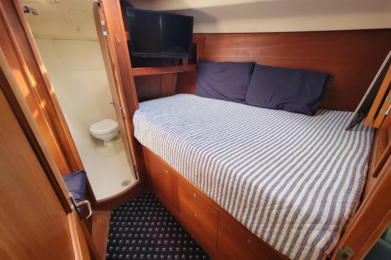 Slide: The Image of Cozy cabin interior of 2001 Hunter Passage 420 yacht with bed and bathroom. - 31