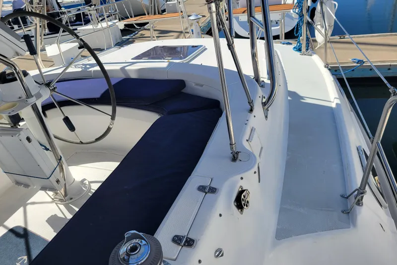 Slide: The Image of 2001 Hunter Passage 420 sailboat cockpit with steering wheel and seating, docked at marina. - 7