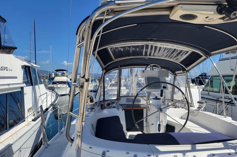 Slide: The Image of Cockpit of 2001 Hunter Passage 420 sailboat docked in marina under clear blue sky. - 8