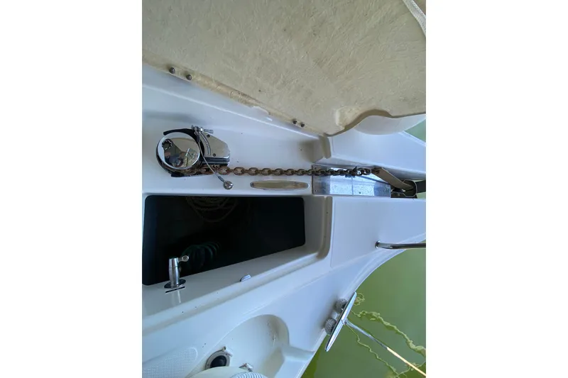 Slide: The Image of 2002 Silverton 330 Sport Bridge anchor chain and storage compartment on deck. - 13