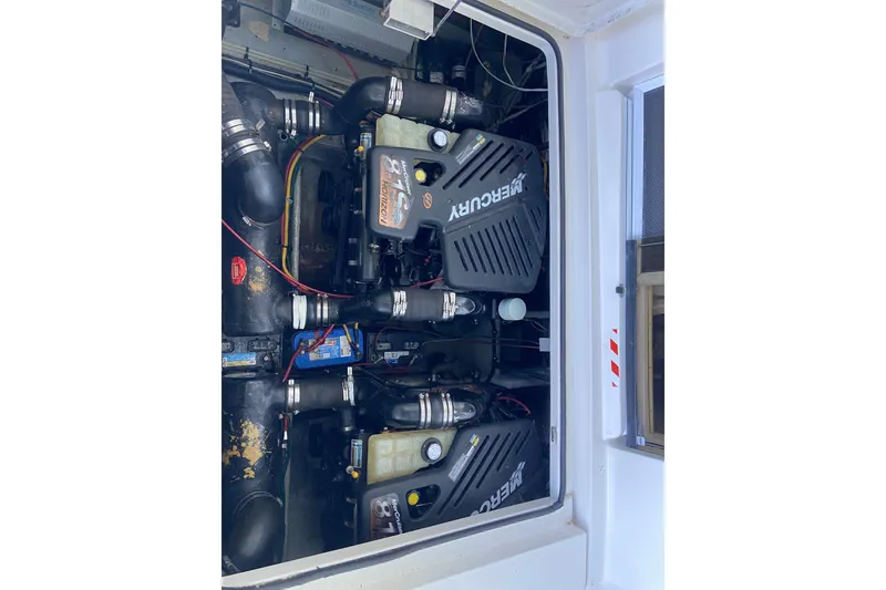 Slide: The Image of Engine compartment of a 2002 Silverton 330 Sport Bridge with twin Mercury engines. - 15