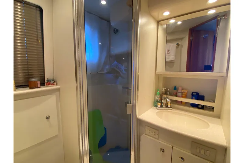 Slide: The Image of Bathroom interior of 2002 Silverton 330 Sport Bridge yacht with shower and vanity. - 26