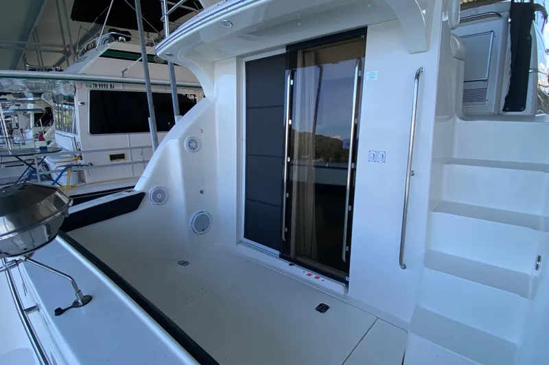 Slide: The Image of 2002 Silverton 330 Sport Bridge yacht with sliding glass door and outdoor seating area. - 4