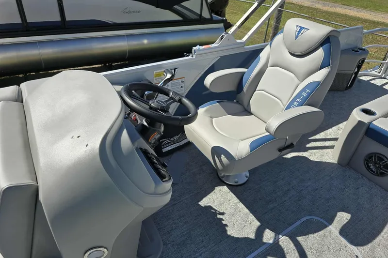 Slide: The Image of 2026 Trifecta 25LE boat interior with steering wheel and captain's chair. - 5