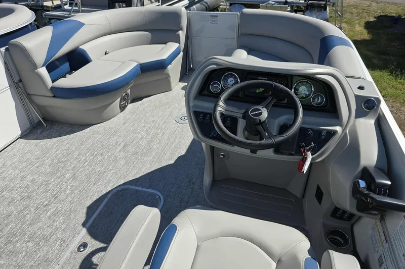 Slide: The Image of Interior of 2026 Trifecta 25LE boat with modern steering console and plush seating. - 7