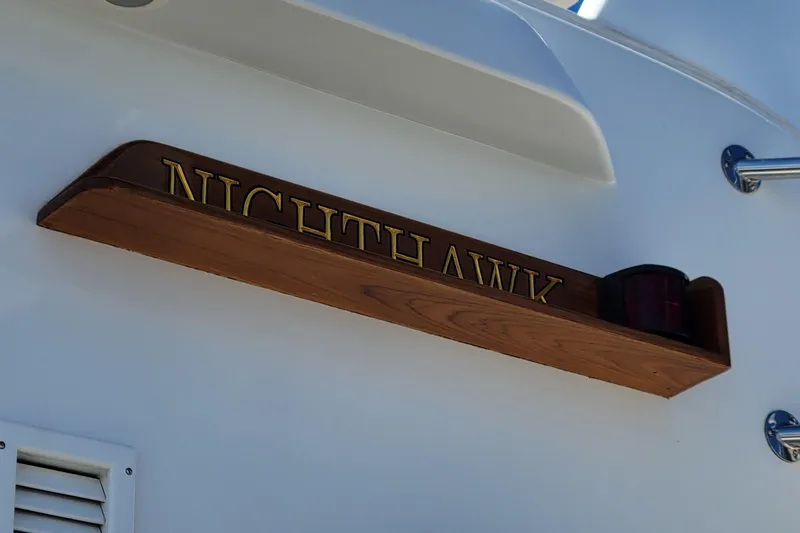 Slide: The Image of Nameplate "NIGHTHAWK" on 1999 Lyman-Morse pilothouse boat, wooden design with light. - 10