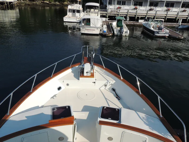 Slide: The Image of Bow view of 1999 Lyman-Morse pilothouse yacht docked at marina. - 12