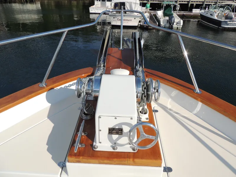 Slide: The Image of 1999 Lyman-Morse pilothouse boat deck with anchor winch and polished wood finish. - 16