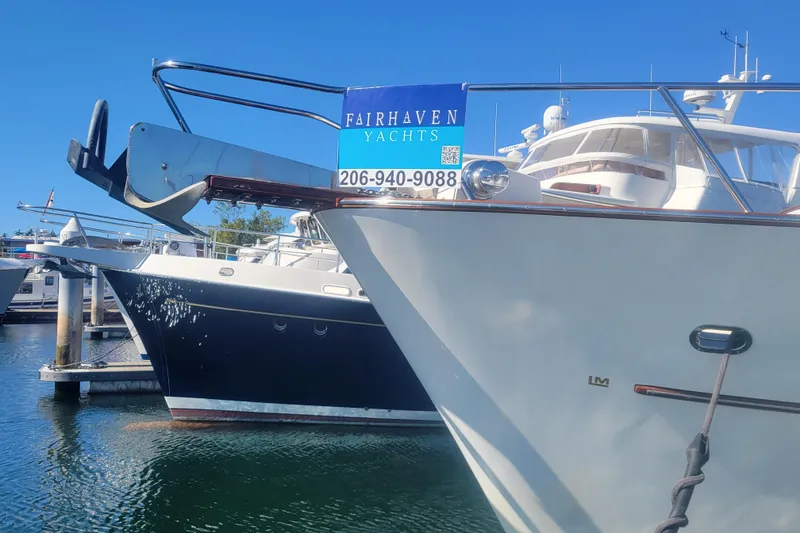 Slide: The Image of 1999 Lyman-Morse pilothouse yacht docked at marina, Fairhaven Yachts sign visible. - 17