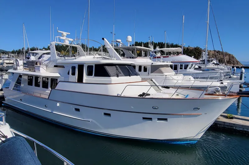Slide: The Image of 1999 Lyman-Morse pilothouse yacht docked in a marina under clear blue skies. - 2