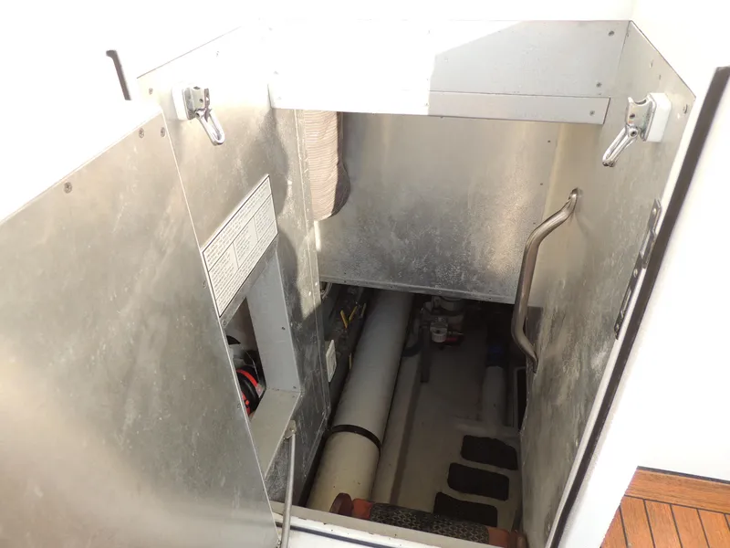 Slide: The Image of Engine room access on 1999 Lyman-Morse pilothouse boat, featuring metal walls and handrails. - 22