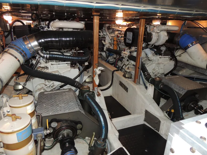 Slide: The Image of Engine room of a 1999 Lyman-Morse pilothouse yacht, showcasing mechanical components and piping. - 25