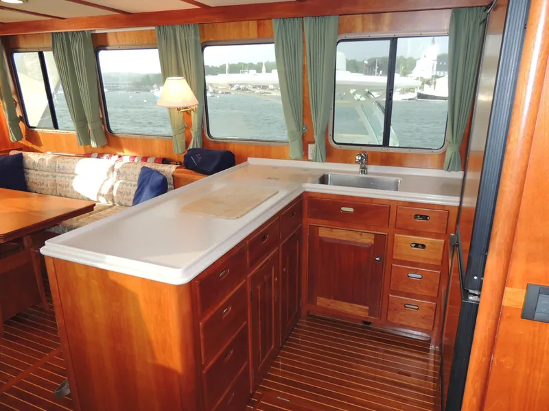 Slide: The Image of Interior of 1999 Lyman-Morse pilothouse with wooden cabinetry and large windows. - 29