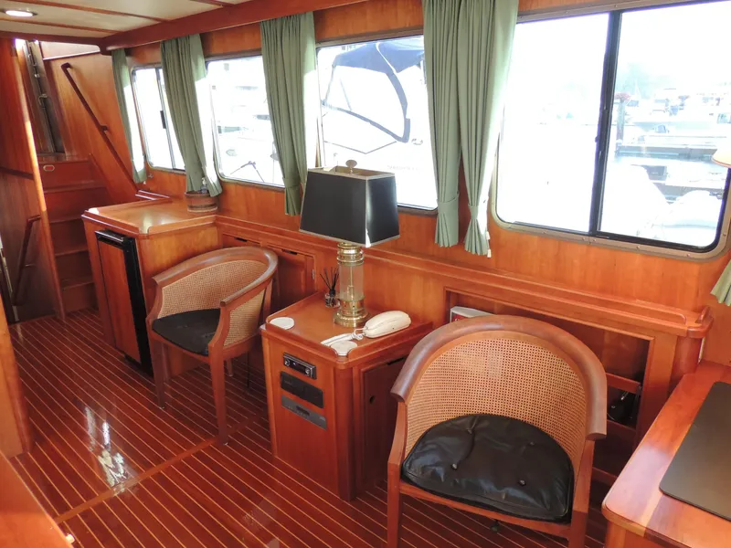 Slide: The Image of Luxurious 1999 Lyman-Morse pilothouse interior with wooden furnishings and elegant seating. - 30