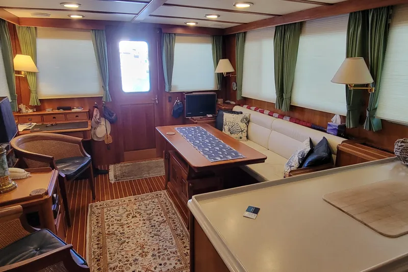 Slide: The Image of Luxurious 1999 Lyman-Morse pilothouse interior with elegant wood finishes and comfortable seating. - 32