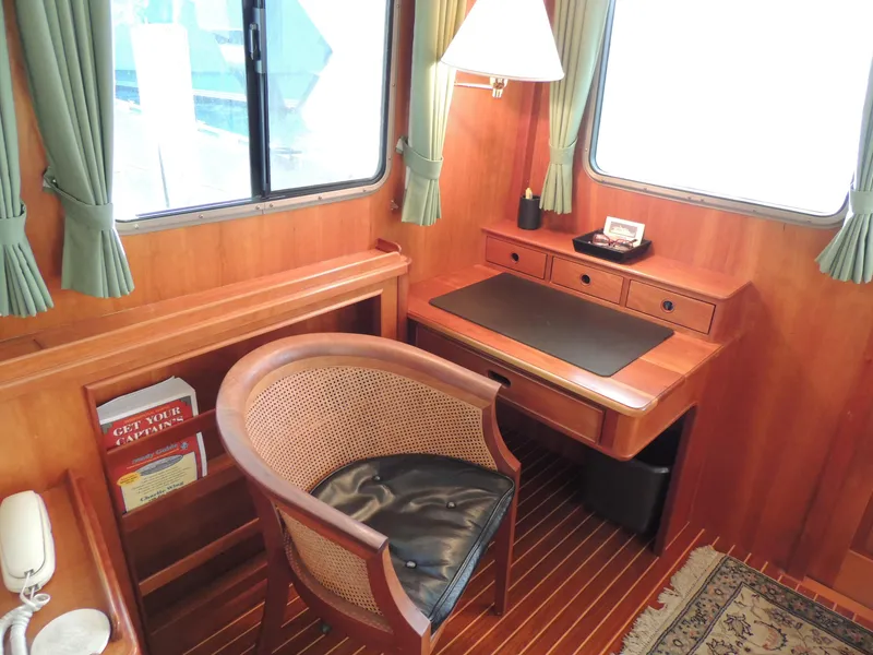 Slide: The Image of Luxurious 1999 Lyman-Morse pilothouse interior with wooden desk and chair. - 33