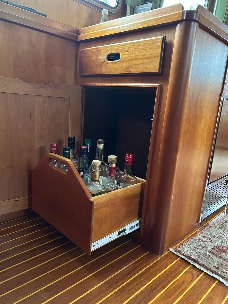 Slide: The Image of Wooden cabinet with pull-out liquor storage on a 1999 Lyman-Morse pilothouse boat. - 34