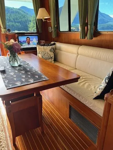 Slide: The Image of Luxurious 1999 Lyman-Morse pilothouse interior with elegant seating and scenic views. - 35