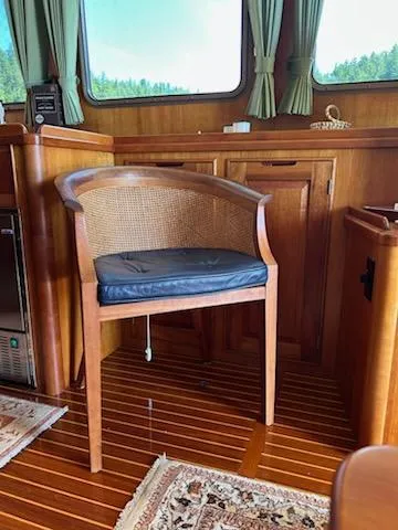 Slide: The Image of 1999 Lyman-Morse pilothouse interior with wooden chair and elegant decor. - 36