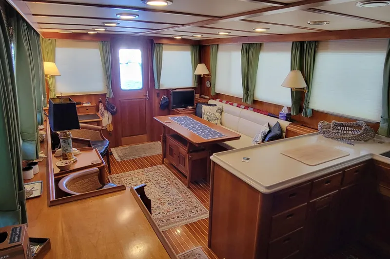 Slide: The Image of Luxurious 1999 Lyman-Morse pilothouse interior with elegant wood finishes and cozy seating area. - 38
