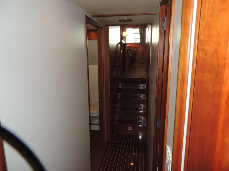 Slide: The Image of Interior of 1999 Lyman-Morse pilothouse yacht with wooden finishes and staircase. - 41
