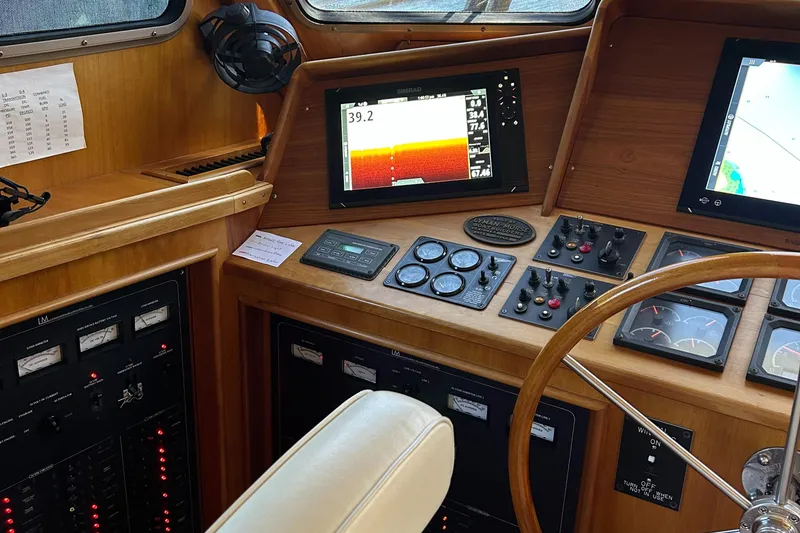 Slide: The Image of Pilothouse interior of 1999 Lyman-Morse boat, featuring navigation instruments and control panels. - 43