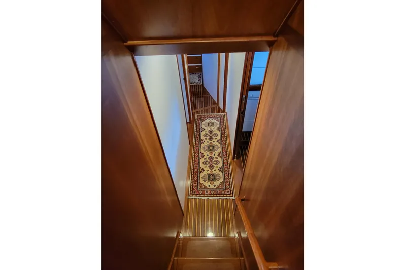 Slide: The Image of Interior of 1999 Lyman-Morse pilothouse with wooden stairs and decorative rug. - 47