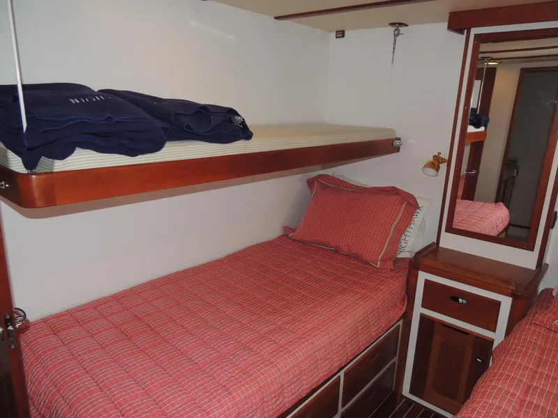 Slide: The Image of 1999 Lyman-Morse pilothouse cabin with bunk beds and red bedding. - 49