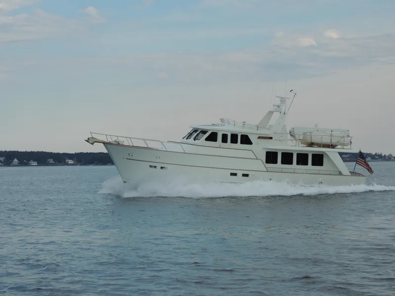 Slide: The Image of 1999 Lyman-Morse pilothouse yacht cruising on calm waters. - 5