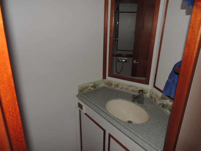 Slide: The Image of Bathroom interior of 1999 Lyman-Morse pilothouse with sink, mirror, and wooden accents. - 51