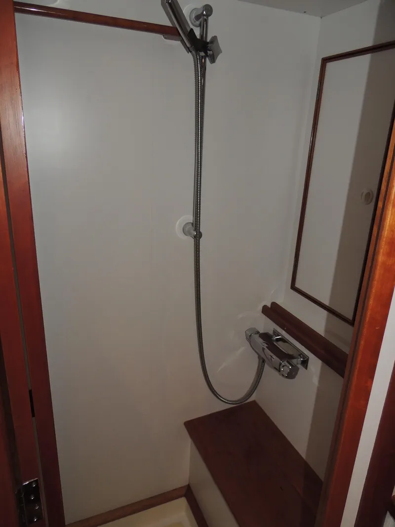 Slide: The Image of Shower area in 1999 Lyman-Morse pilothouse boat with wooden accents and handheld showerhead. - 59