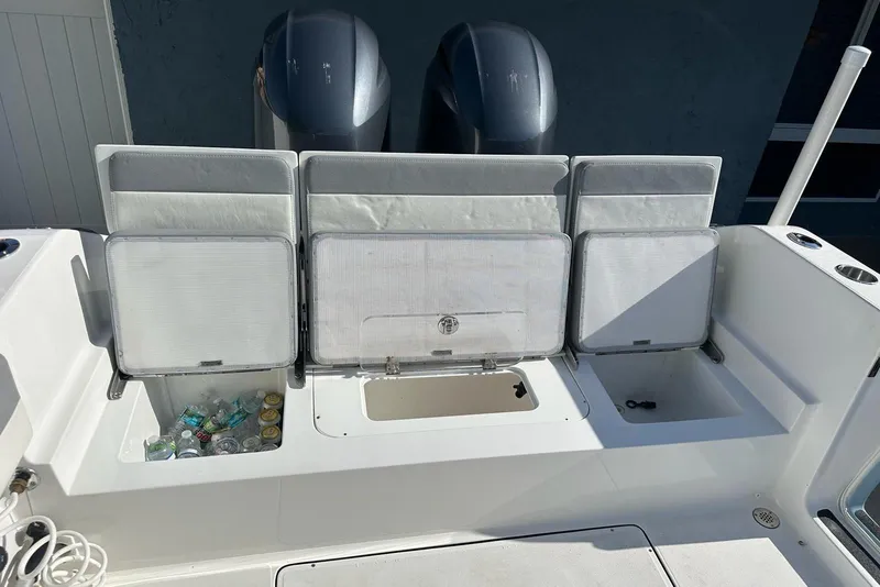 Slide: The Image of Interior of 2019 Release 240 RX boat with storage compartments and beverage holders. - 14