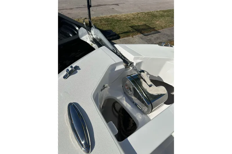 Slide: The Image of 2019 Release 240 RX boat anchor system with chrome details and textured deck surface. - 18