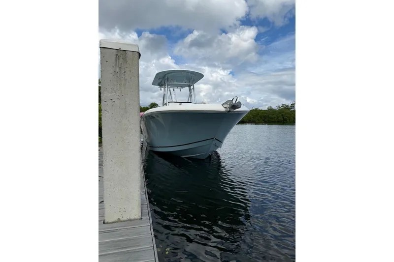 Slide: The Image of 2019 Release 240 RX boat docked on calm water under cloudy sky. - 4