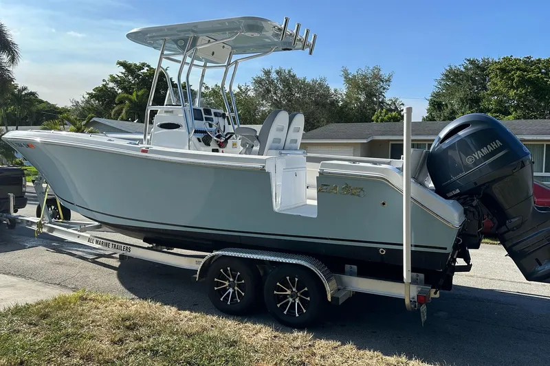 Slide: The Image of 2019 Release 240 RX boat on trailer with Yamaha outboard motor, parked in residential area. - 5
