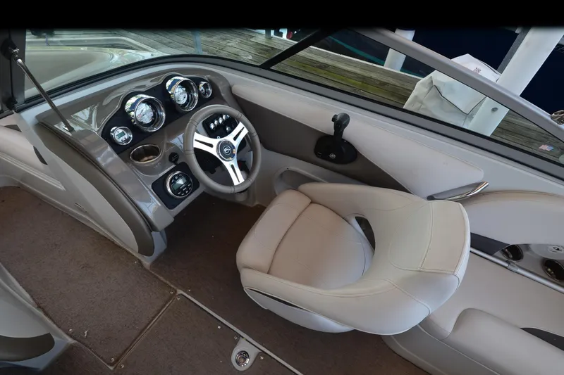 Slide: The Image of 2018 Crownline 205 SS boat interior with steering wheel and dashboard controls. - 11