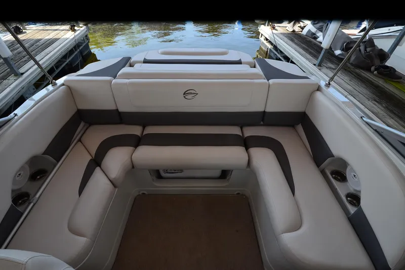 Slide: The Image of 2018 Crownline 205 SS boat interior with cushioned seating and cup holders. - 14