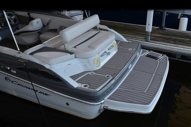 Slide: The Image of 2018 Crownline 205 SS boat with spacious seating and swim platform at dock. - 15
