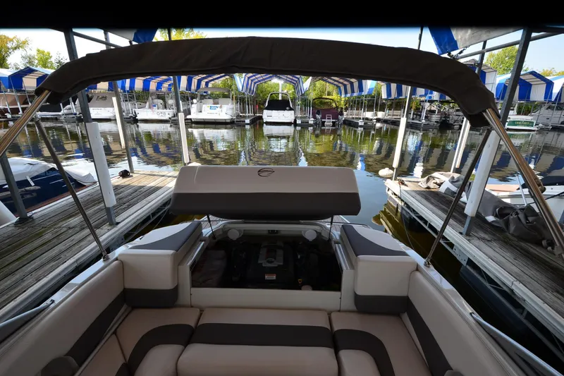 Slide: The Image of 2018 Crownline 205 SS boat docked at marina with striped canopies. - 20