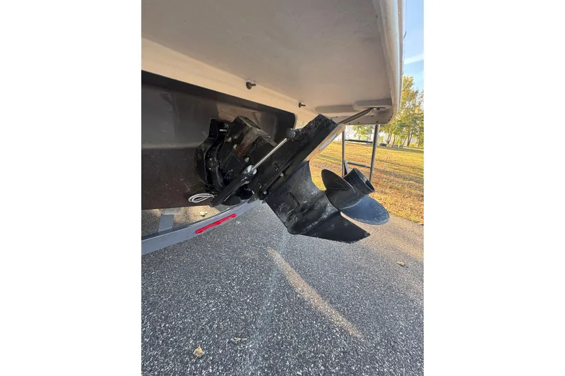Slide: The Image of Rear view of 2018 Crownline 205 SS boat propeller and outdrive on pavement. - 24