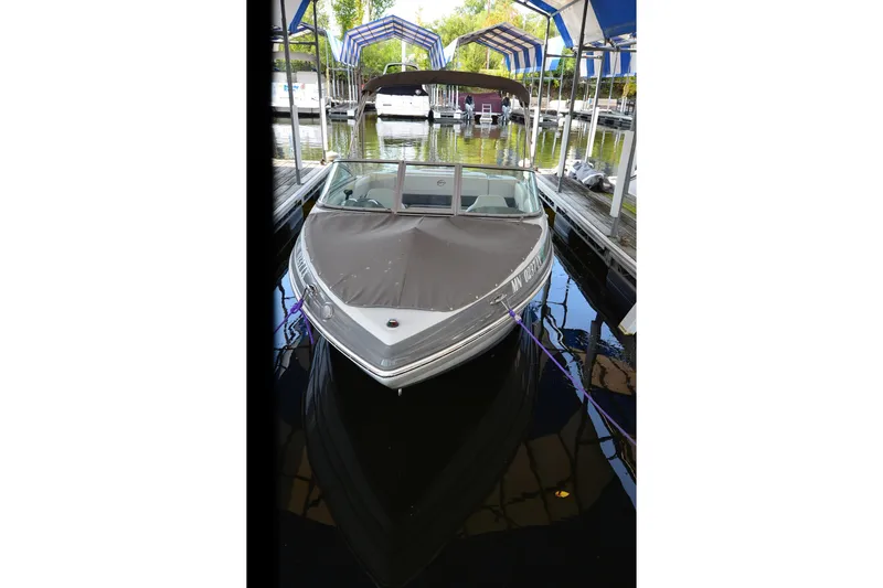 Slide: The Image of 2018 Crownline 205 SS boat docked under canopy. - 6