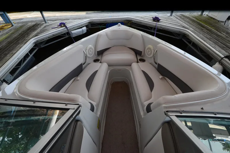 Slide: The Image of 2018 Crownline 205 SS boat interior with cushioned seating and cup holders. - 7