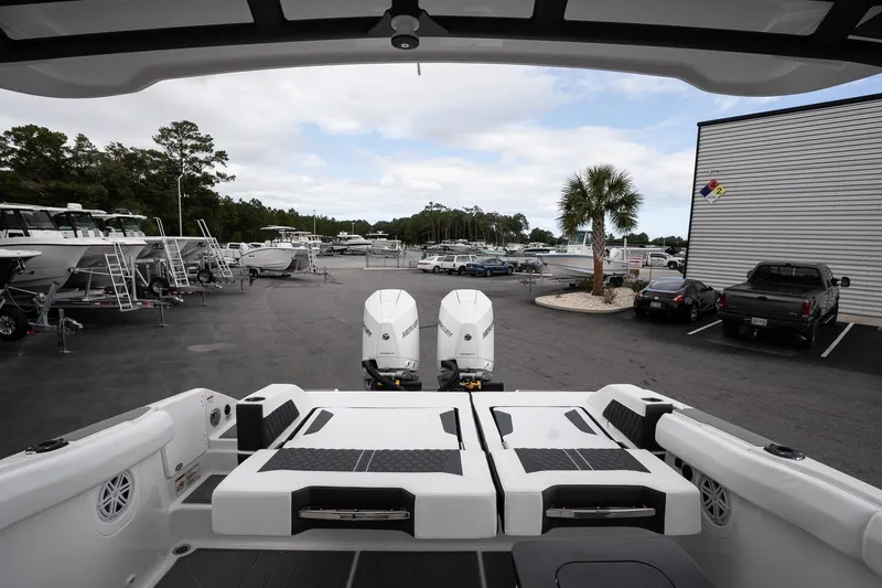 Slide: The Image of 2026 Monterey Elite 30 OB boat with dual engines in a marina setting. - 15