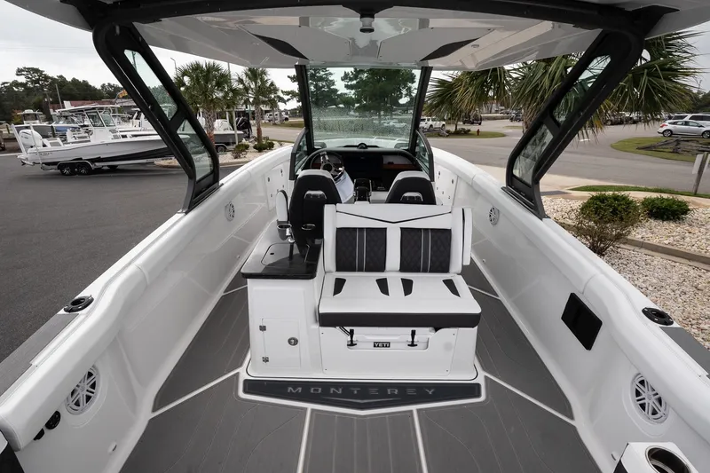 Slide: The Image of 2026 Monterey Elite 30 OB boat interior with seating and helm, showcasing modern design. - 19