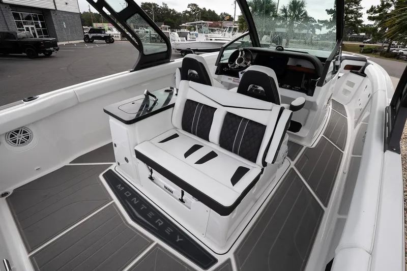 Slide: The Image of 2026 Monterey Elite 30 OB boat interior with sleek seating and modern dashboard design. - 20