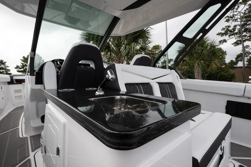 Slide: The Image of 2026 Monterey Elite 30 OB boat interior with sleek seating and modern sink. - 21